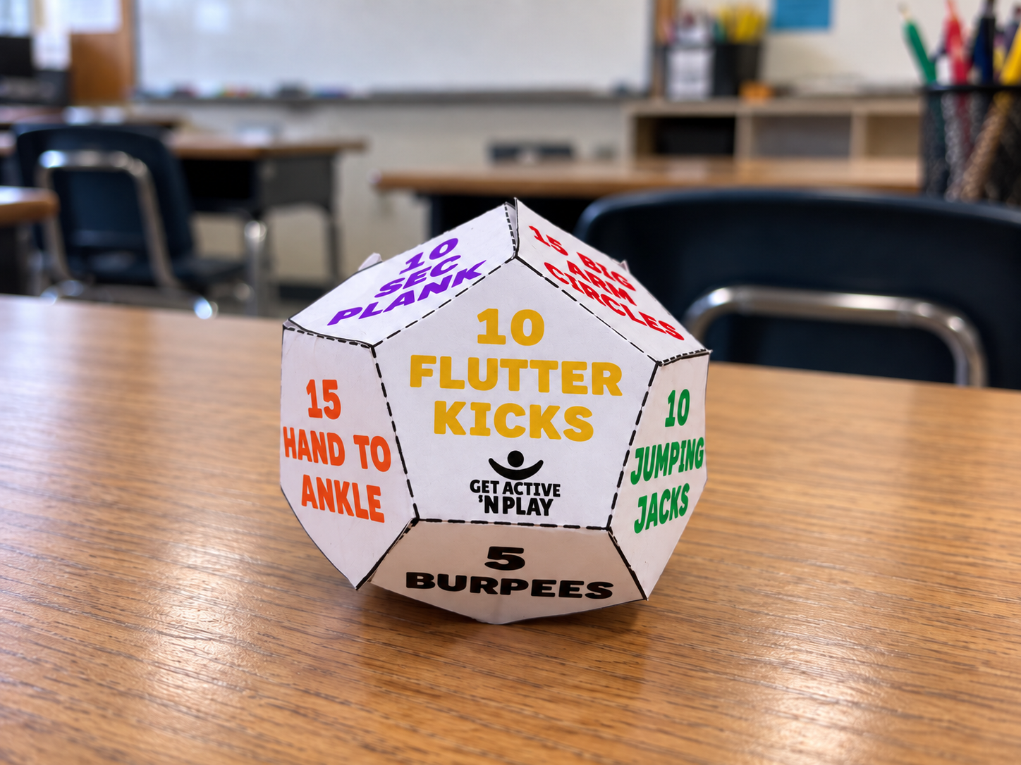 A finished paper exercise dodecahedron sitting on a classroom desk