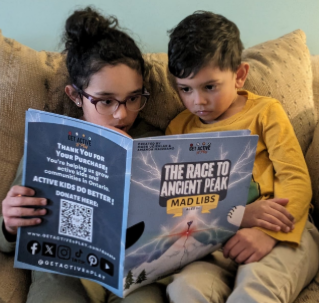 Kids with a Get Active Mad Libs booklet
