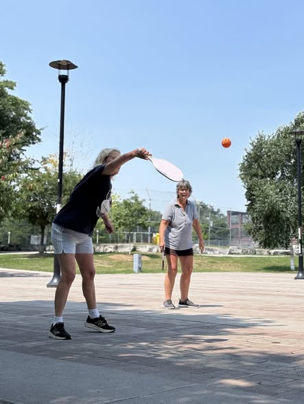Neighbours playing pickleball together at Sorauren Park