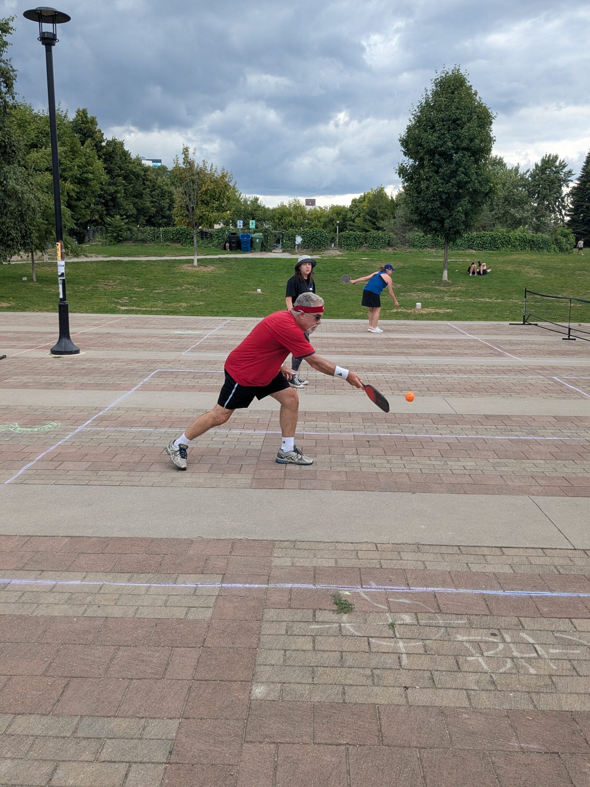 A player mid-rally at the 2025 GANP Pickleball Tournament