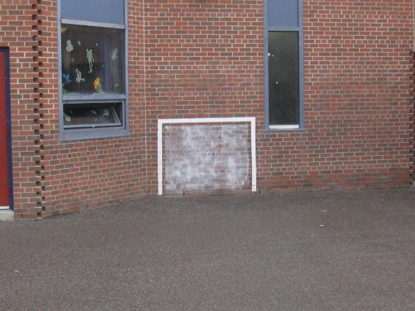 An early white Sportswall hockey goal painted on a brick school wall